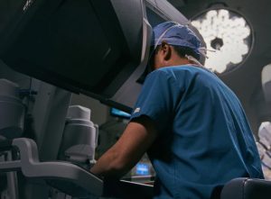 surgeon looking into davinci surgeon console in operating room
